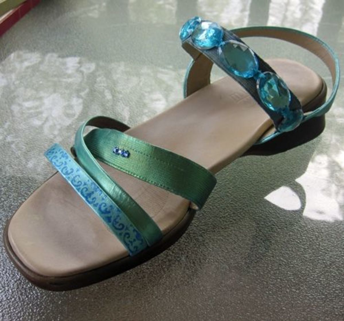 Aqua faux jewels sewn onto the stretched-out elastic strap. 