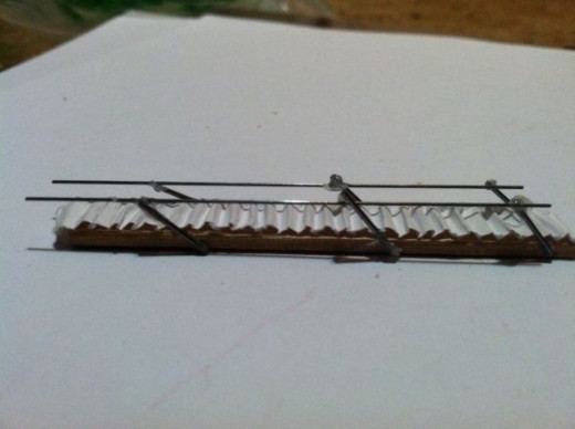 Attach step rails to poles with quick grip glue. Attach to platform, through the hole in the platform