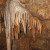 The color of the stalactites and stalagmites in the caverns are created by iron oxide. The color of the stalactites and stalagmites in the caverns are created by iron oxide.