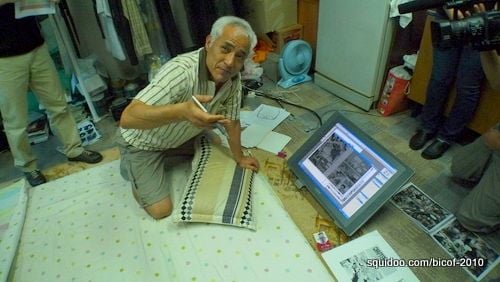 Veteran Korean comic creator Tae San Jang showing us his artworks on a Cintiq.