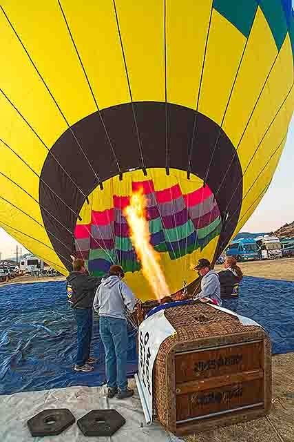 The ballon begins to lift as the burner begins to fill it with hot air