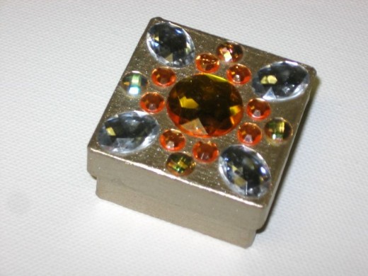 Antique-gold square box with orange and yellow jewels