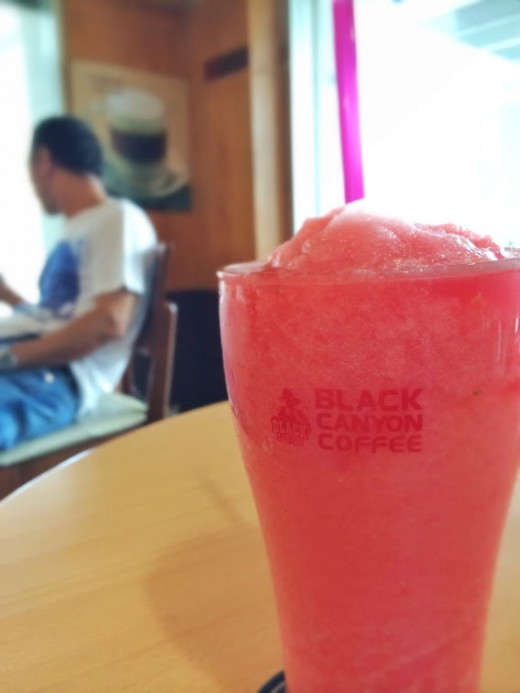 Cooling off with a glass of fresh watermelon shake.