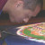 Tiny grains of colored sand sift through tubes to construct the sand mandala Tiny grains of colored sand sift through tubes to construct the sand mandala