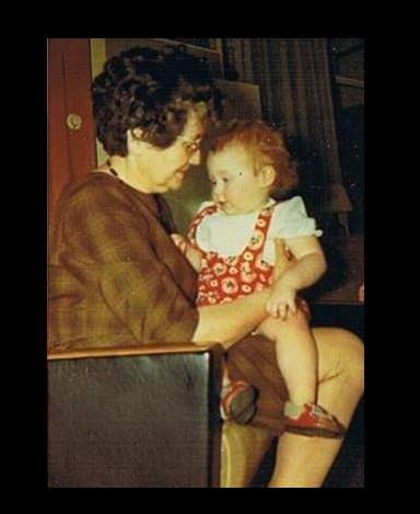 Me as a 2 years old toddler on the lap of my grandmother