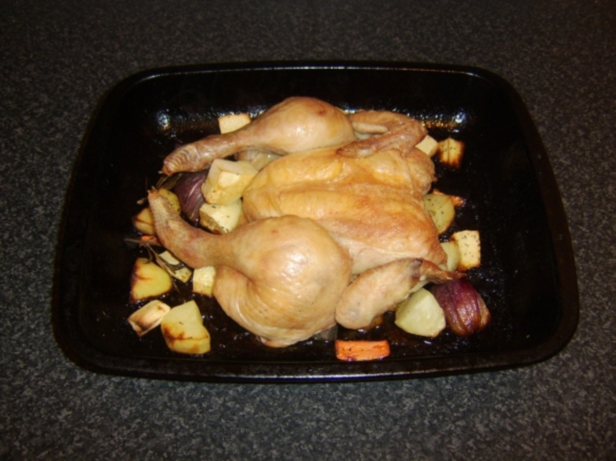 Chicken with its backbone removed roasted on root vegetables