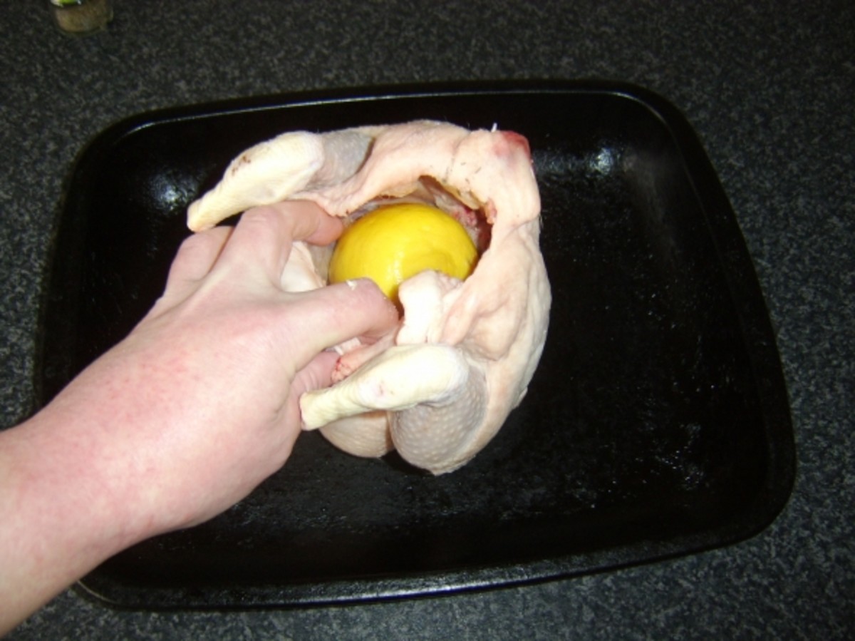 Citrus fruits, thyme and garlic are stuffed in to the chicken