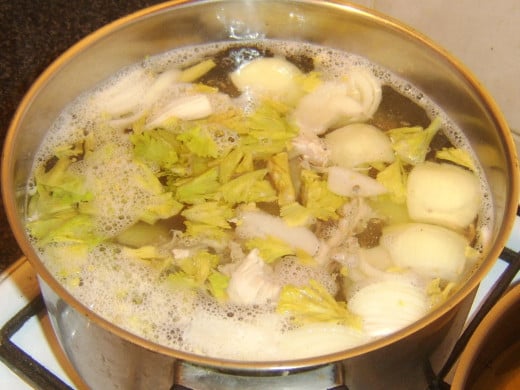 Turkey broth combination is brought to a gentle simmer