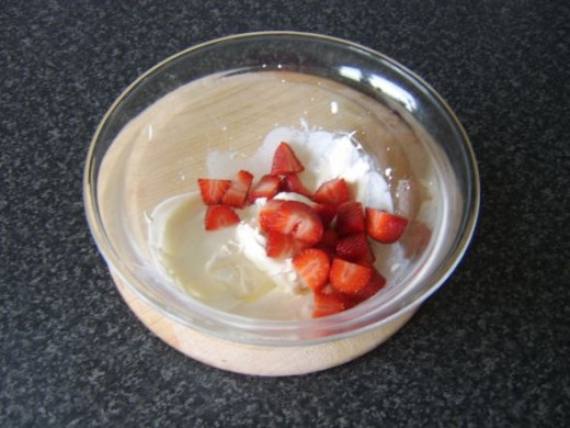 Strawberries are added to whipped cream