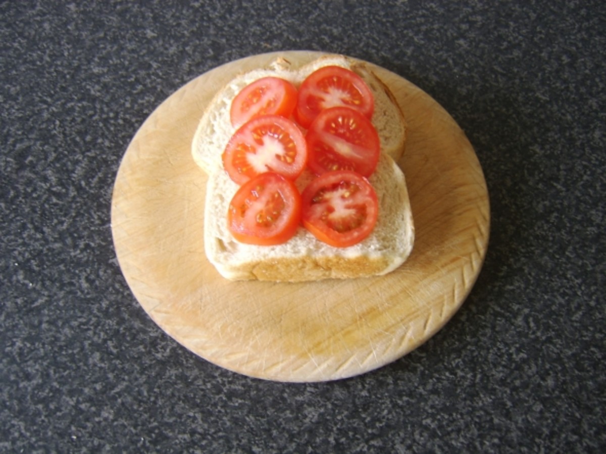 Tomato slices are laid on the untoasted side of the bread