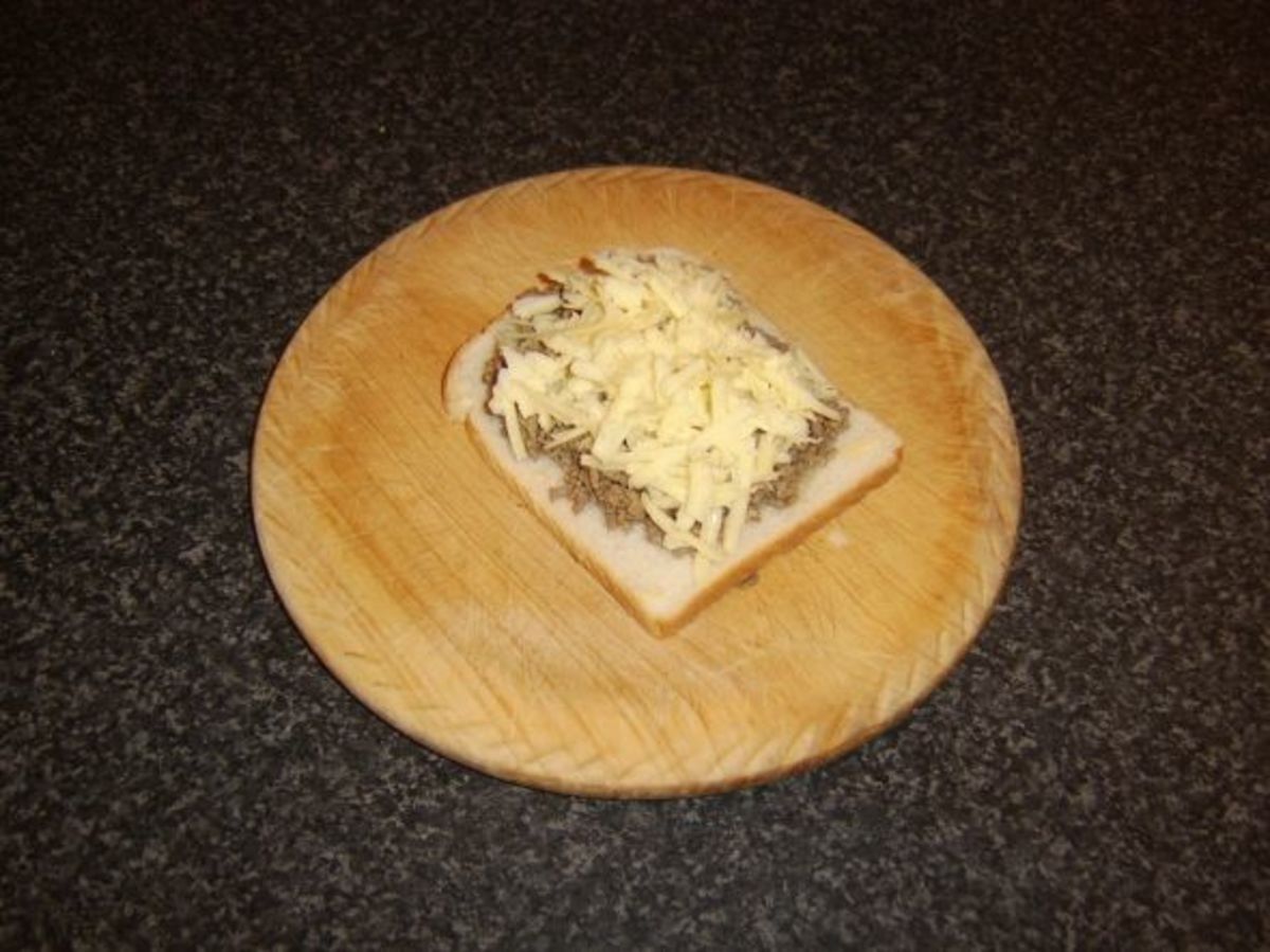 Cheese scattered evenly over beef