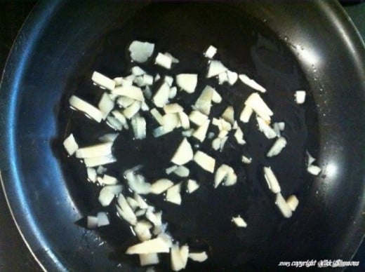 Step 1: Take the chopped water chestnuts and lightly saute them in the hot skillet.