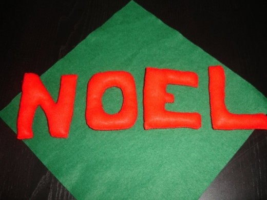 Noel is an alternate word for Christmas. These felt ornaments are going to be hanged on fishing net (invisible) and attached to the door frame.