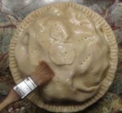 Glazing the pie with egg white