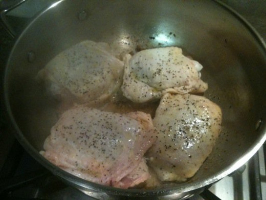 I've seasoned the chicken thighs & placed in the pan with the sausage fat.