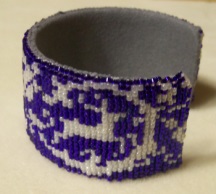 On the right side, you have the deer running from the hunter.The pattern for this bracelet is for sale at http://bit.ly/GoddessofHuntLoomBr-BPB