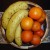 Chequered light and dark solid wood with bananas and oranges Chequered light and dark solid wood with bananas and oranges