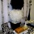 Center Back -- black and white feather topiary as a centerpiece, "Love" plaque on plate stand, milk glass vase with fanned netting