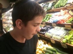 Dylan choosing vegetables for dinner at Fresh Market