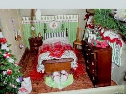 The Claus's bedroom is quaint, right down to Mrs. Claus's fluffy slippers at the end of the bed.