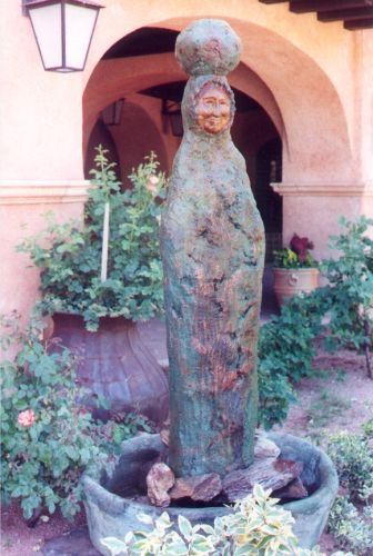 Stone sculpture of a woman with a water pot on her head. Several sculptures like this all seemed to be the same style, very different from the bronze animals.