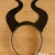 Repeat with the other 2 holes to use the cord to tie the design onto the band. Repeat with the other 2 holes to use the cord to tie the design onto the band.