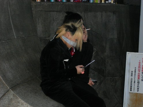 Harajuku Girl trying to avoid the camera.  Many have been stalked so are now wary of being photographed.