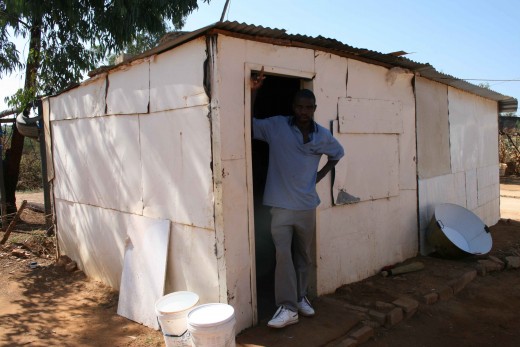 Amos ion the doorway of his house in Mamelodi