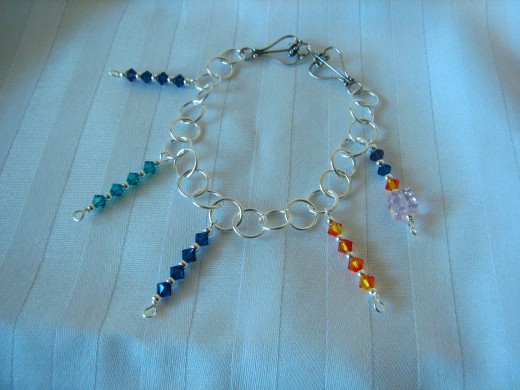 detail of colorful beaded bracelet and sterling silver design by C.S. Alexis