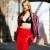 Street sexy fashion as this blonde woman wears a red leather tight skirt with a black leather bra covered with a dull printed jacket. Street sexy fashion as this blonde woman wears a red leather tight skirt with a black leather bra covered with a dull printed jacket.