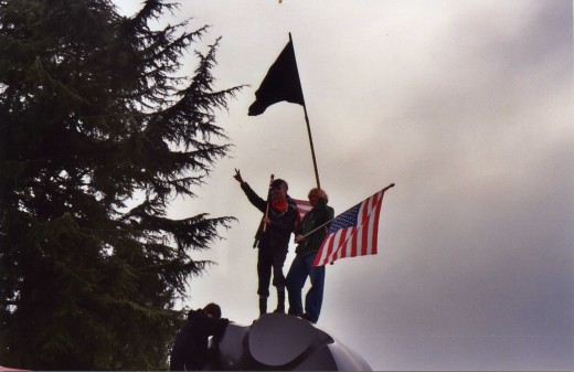 I really like this image: American flag and the peace sign.  However, these two youths are anarchists, making this symbol a bit ironic.