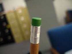 Pencil eraser in front of books