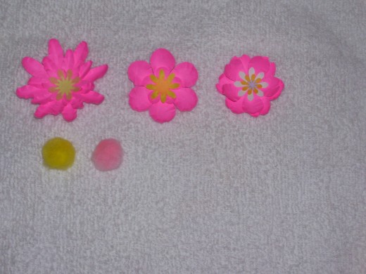 These three flowers are ready for centers.  Two pom-poms have been carefully trimmed on the bottom for this.