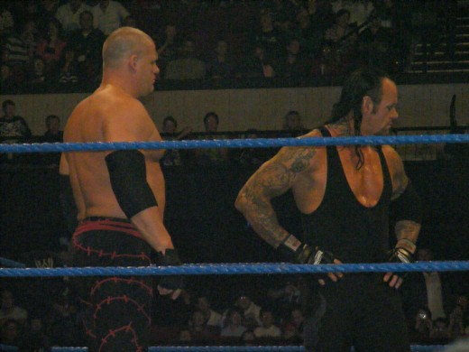 The Undertaker and his half brother Kane have been both partners and feuded with each other. Both are huge men. 