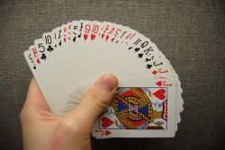 A fanned euchre deck and score cards