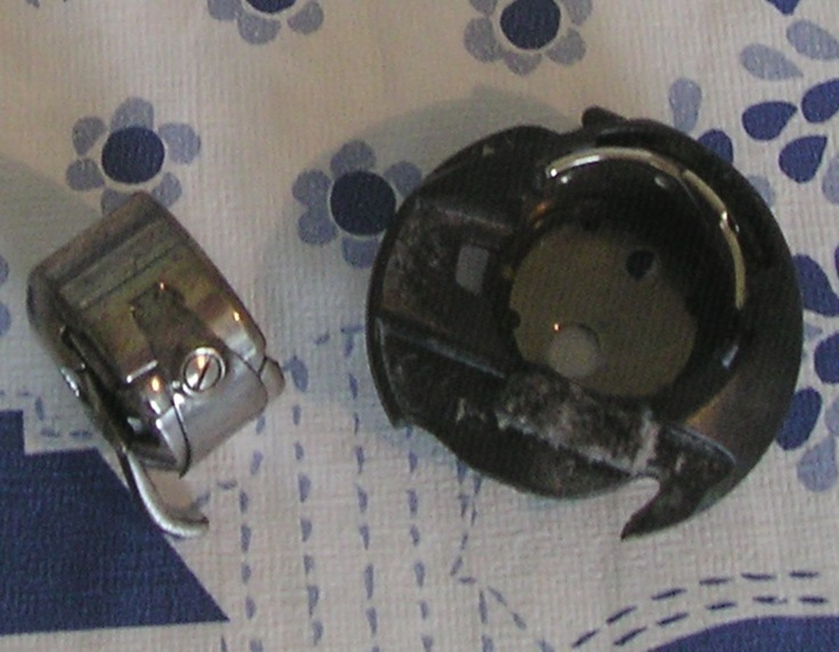 Here are two bobbin holders. Both have channels to control the tension. The left is for a vertical bobbin, and the right is for a top-loading bobbin,.