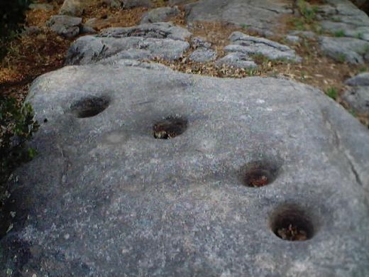 The metate rocks where Serrano Indian women used to grind acorn meal.  The Serrano Indians made their camp at the metate rocks each fall.