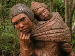 Looking into the face of this statue carved from wood, you can see sorrow on this mothers face.