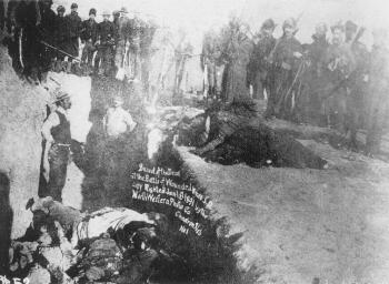 Civilian grave diggers bury the Lakota dead in  a mass grave.