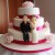 3 tiered pink roses wedding cake with bride and groom figures