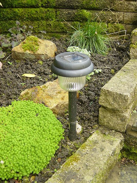 The most common easy-install method for a solar-powered light involves driving the spike at the bottom on the light into soil.