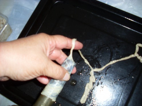 Although I enjoy pounding the meat, this is my favourite part of the whole porocess.  You put the hog casing onto the end of the funnel and then grip the funnel between thumb and pointer finger, and then gently move your your arm in like a wanking mo