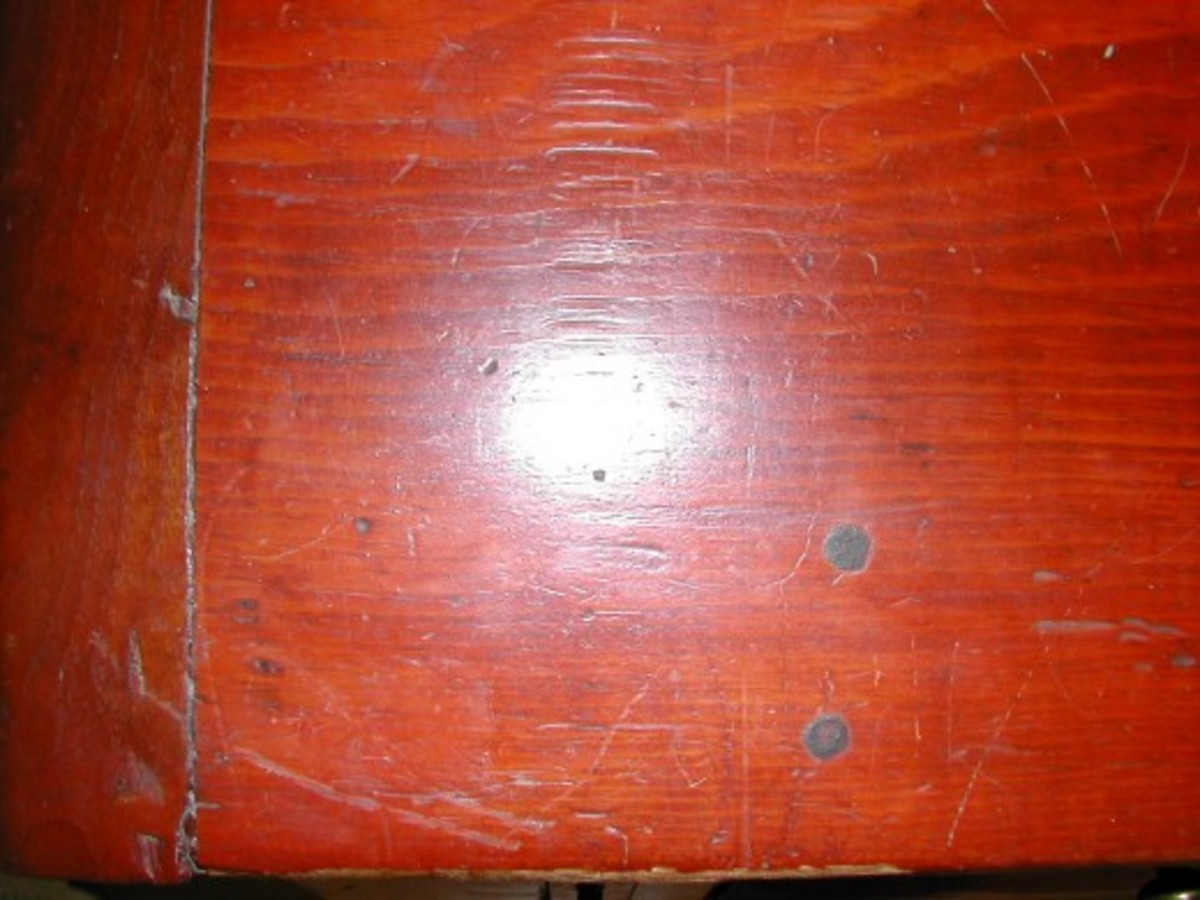 Detail on left side of slant top, showing wooden pegs.