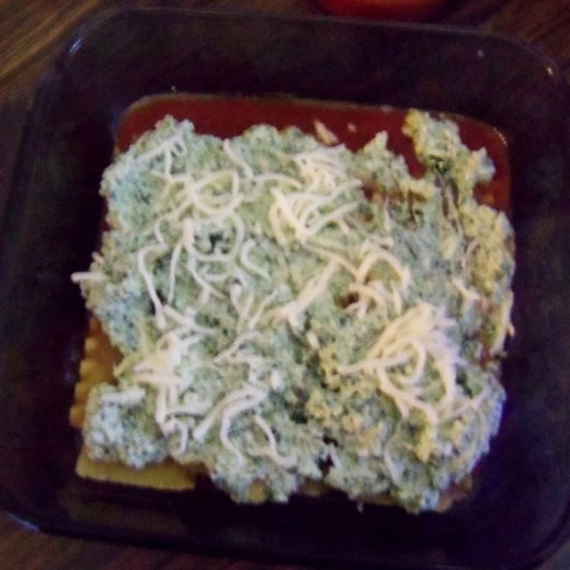 Add cheese mix, spinach (if you haven't mixed it in the cheese already) Add sauce, sprinkle shredded cheese on top.