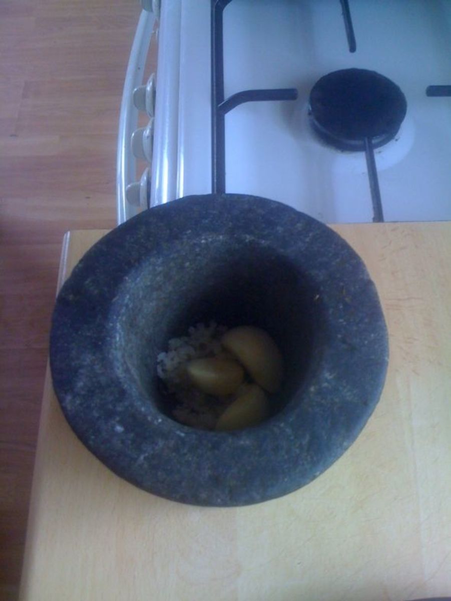 Use a granite mortar and pestle to crush the garlic, salt and pepper.