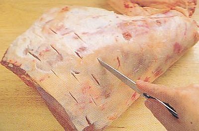Cut small slits in the lamb leg