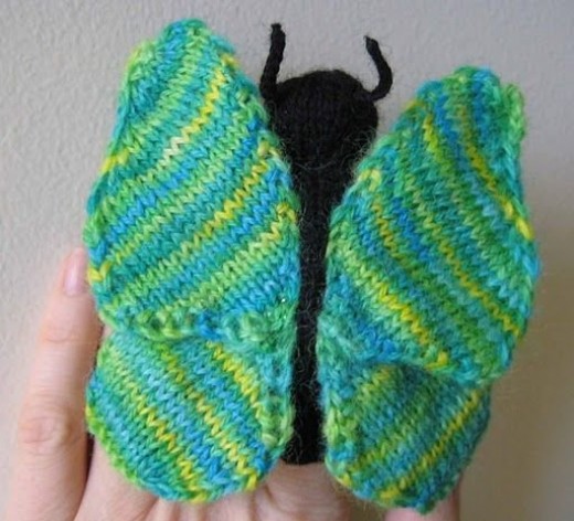 A butterfly finger puppet, knit with this colorway