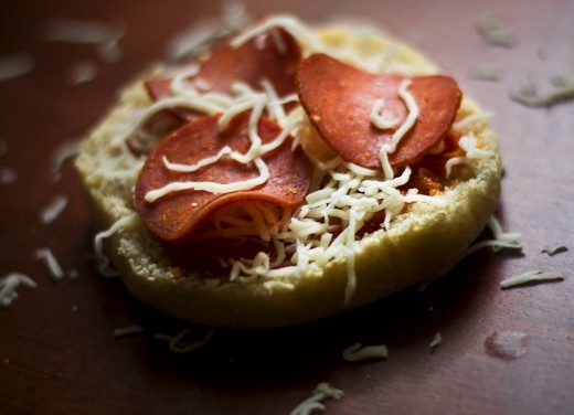 A make your own mini pizza with sauce, shredded mozzarella cheese, and pepperoni on this English muffin.