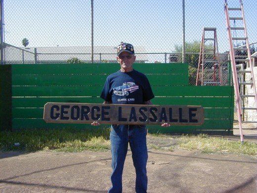 My Dad with the sign that graces the ball field named in his honor.
