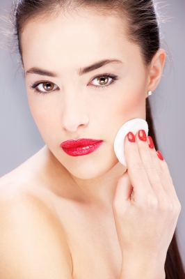 Applying foundation with a round, classic cosmetic sponge